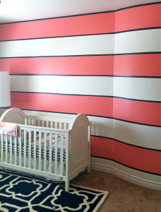 Striped baby girl nursery. Coral pink, navy, and white stripes.