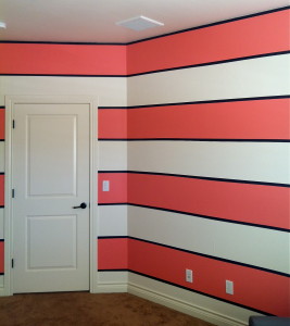 Another view of the baby girl striped nursery. Bright pink, navy blue, and white.